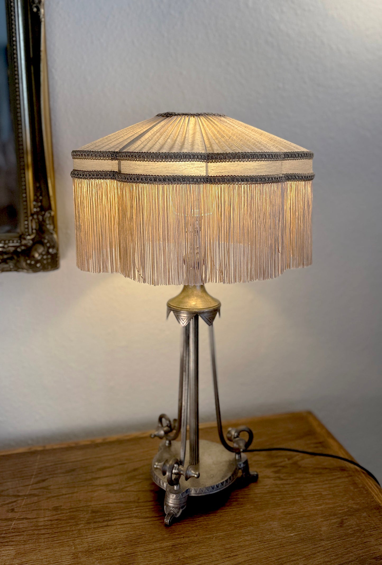 Table lamp with a decorative shade on a wooden surface