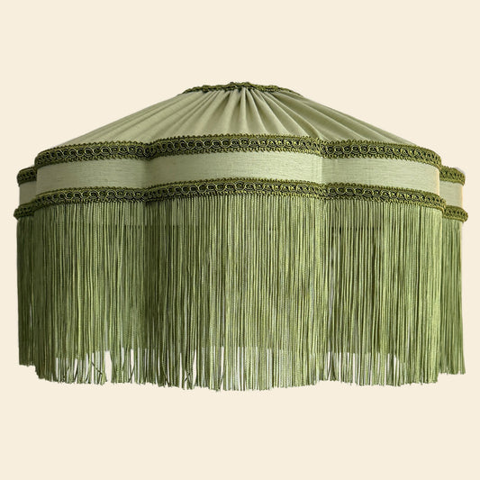 Green lampshade with fringe on a beige background The House of Soft Light