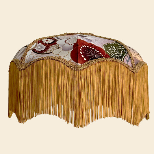 Japanese silk lampshade with floral patterned top and gold fringe on a beige background. The House of Soft Light