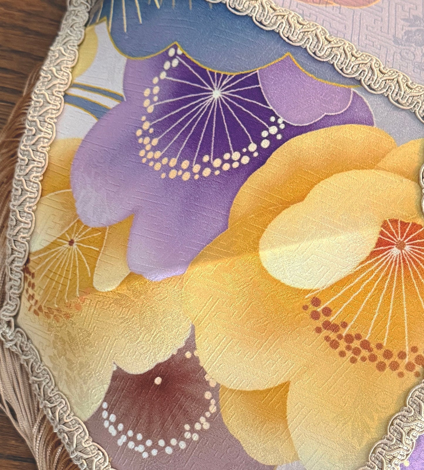 Close-up of a decorative Japanese silk fabric lampshade with floral patterns and gold trim. The House of Soft Light