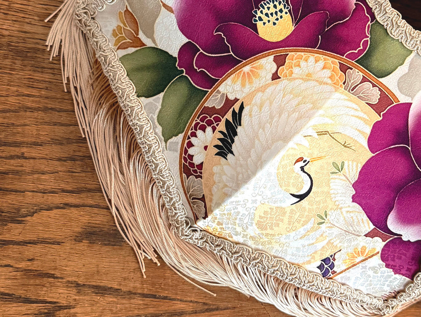Japanese silk lampshade closer look with floral design on a wooden surface