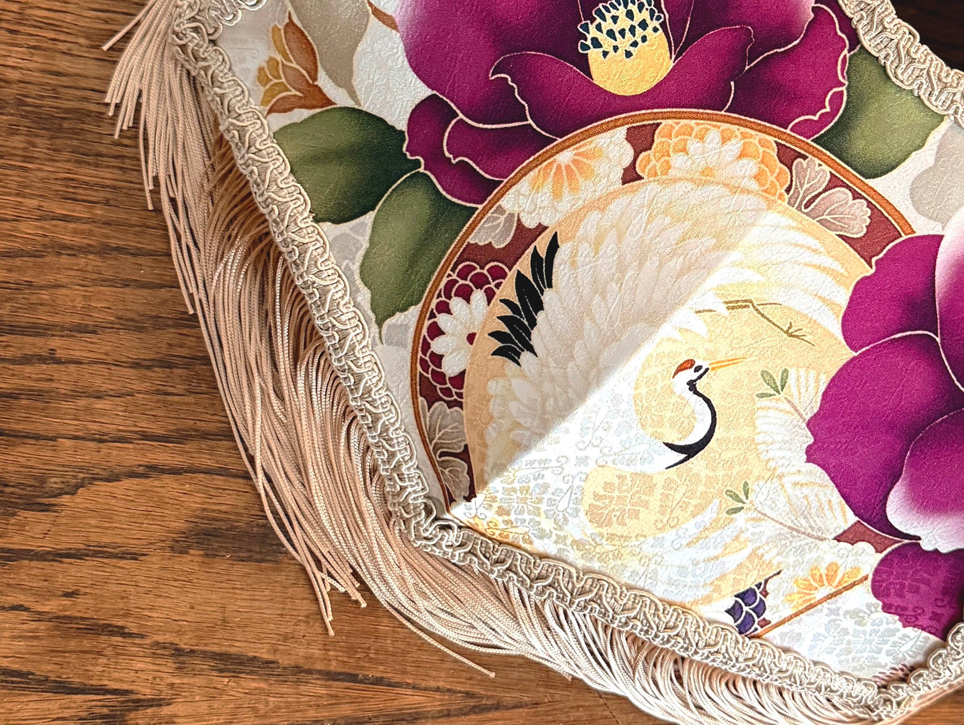 Japanese silk lampshade closer look with floral design on a wooden surface