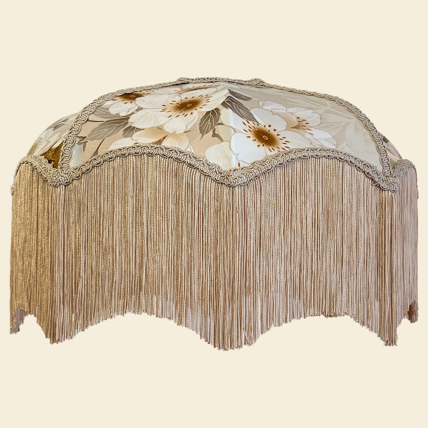 Decorative lampshade with floral pattern and fringe on a beige background The House of Soft Light