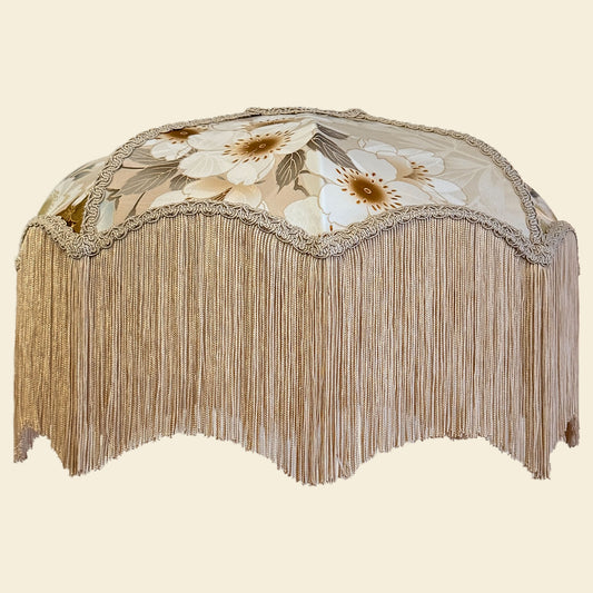 Decorative lampshade with floral pattern and fringe on a beige background The House of Soft Light