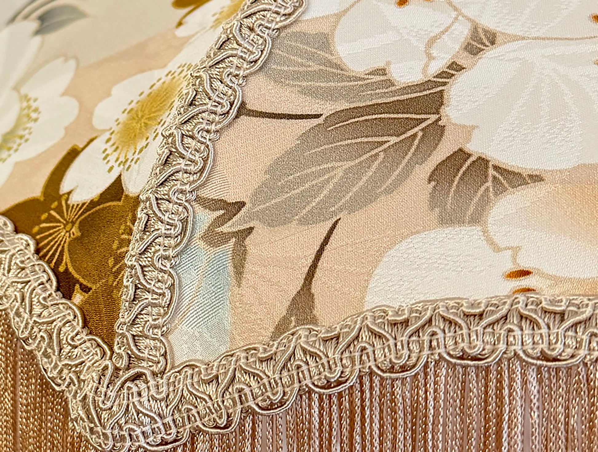 Close-up of floral fabric with lace trim lampshade on a beige background The House of Soft Light