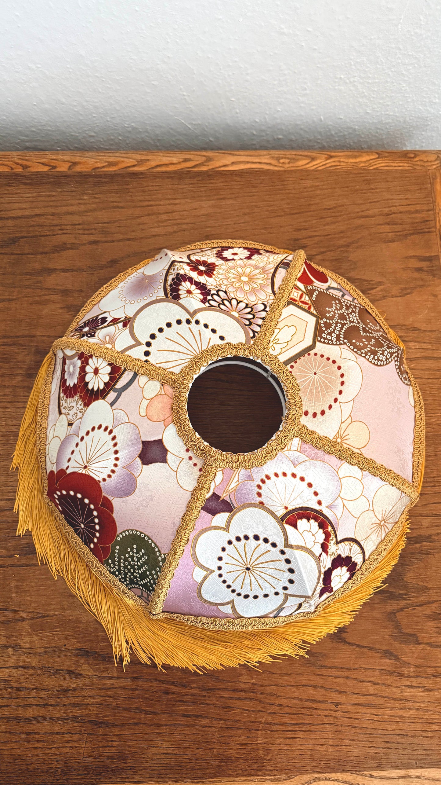 Japanese silk lampshade with floral pattern on a wooden surface