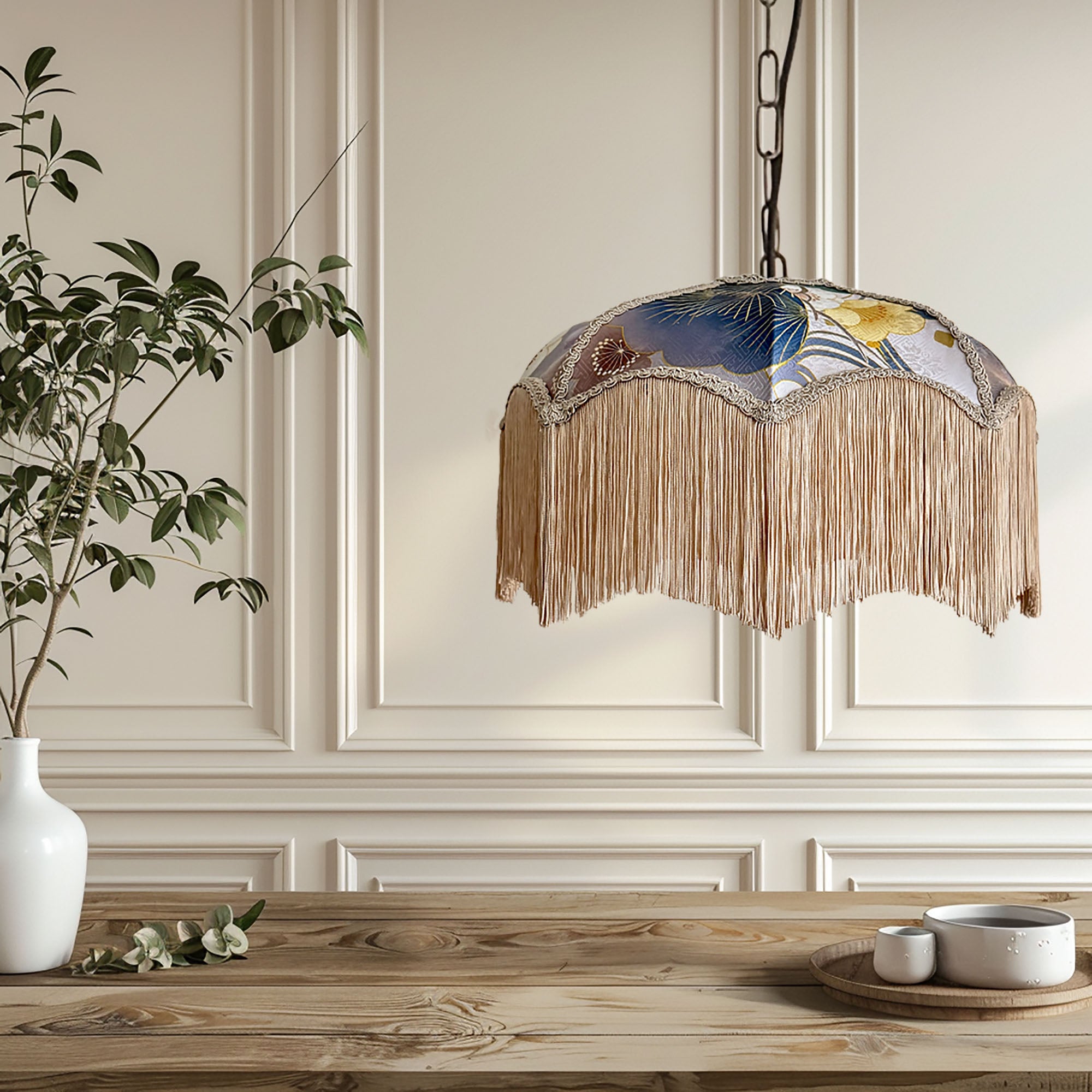 Decorative pendant light with stained glass design and fringe hanging above a wooden table.