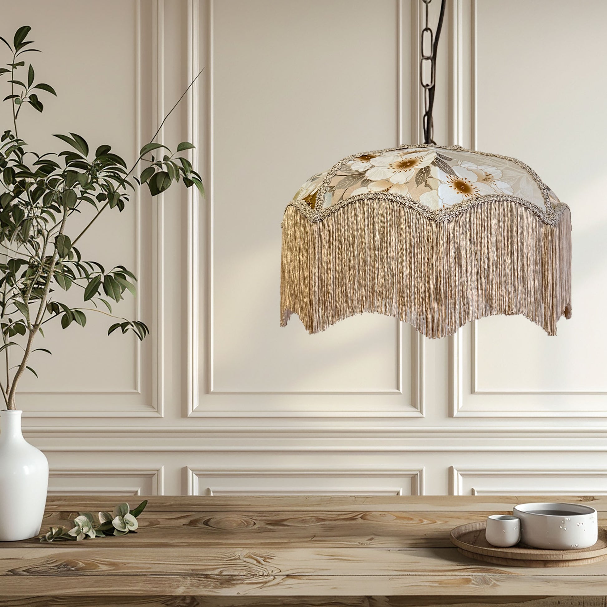 Decorative pendant light with floral design hanging above a wooden table.