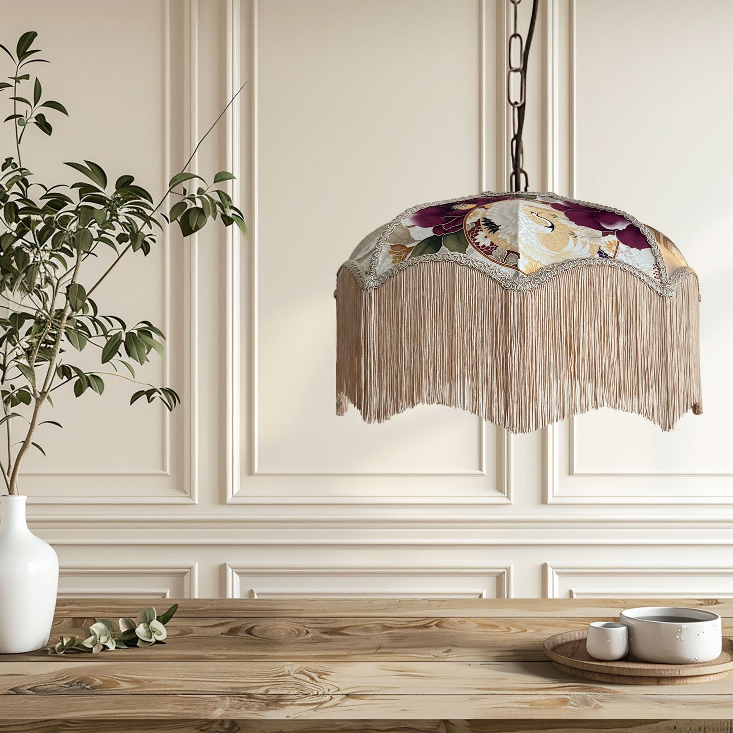 Decorative ceiling light fixture with fringe design in a room with wooden table and plant. The House of Soft Light