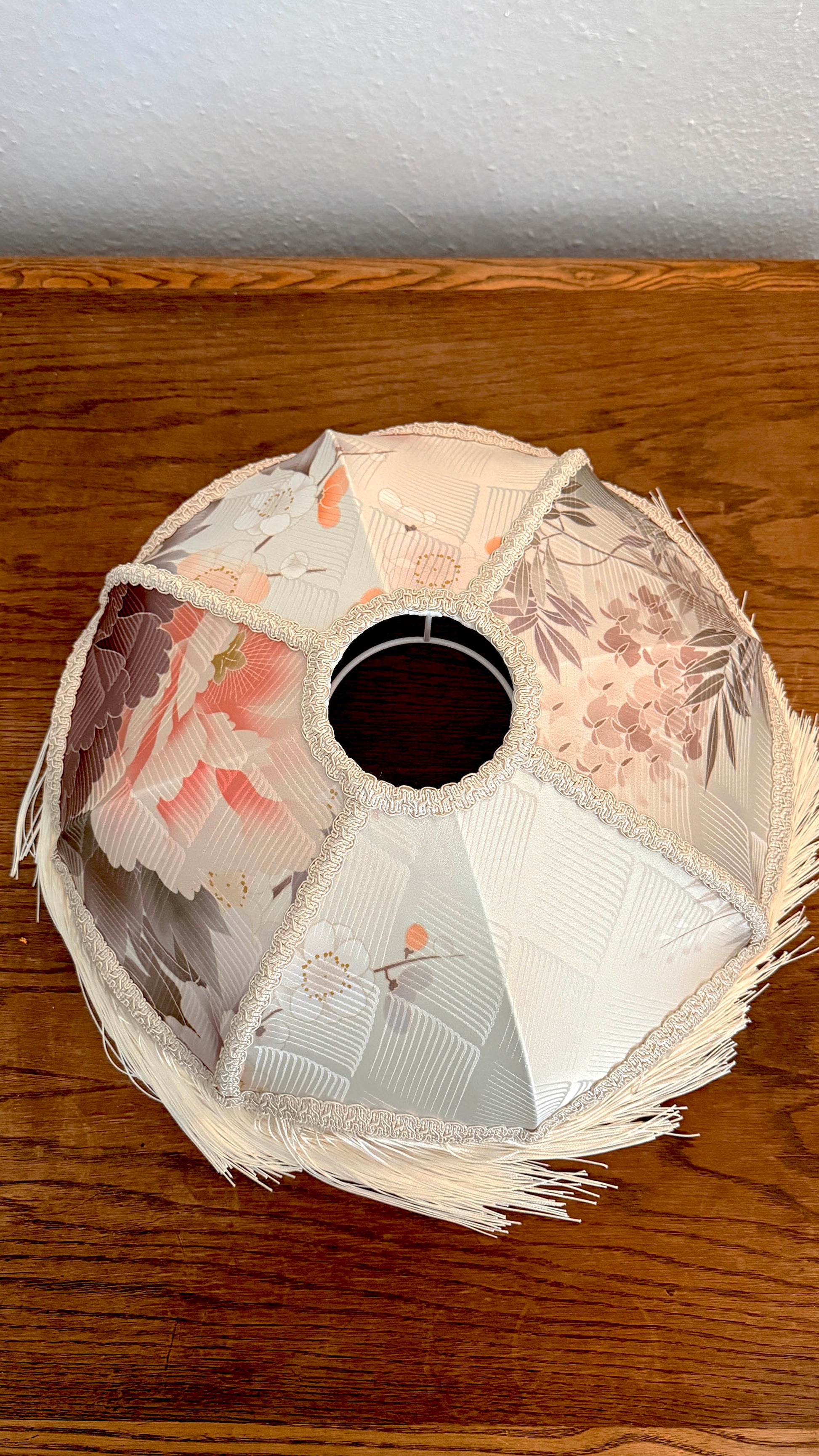 Decorative lampshade with floral pattern on a wooden surface. The House of Soft Light