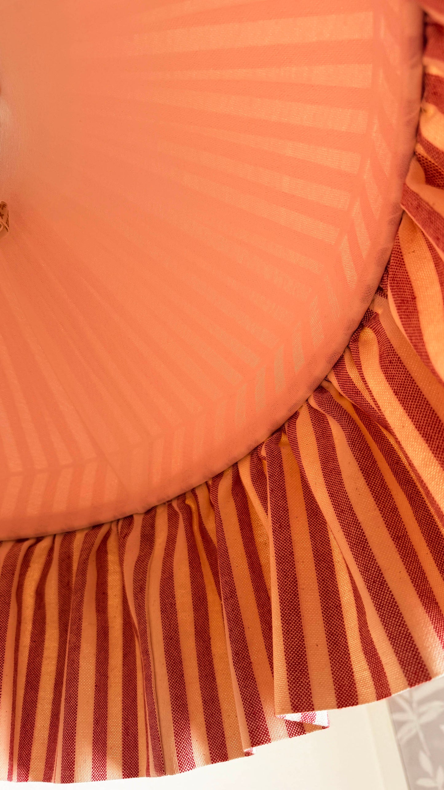 Close-up of a striped fabric lampshade with a lining