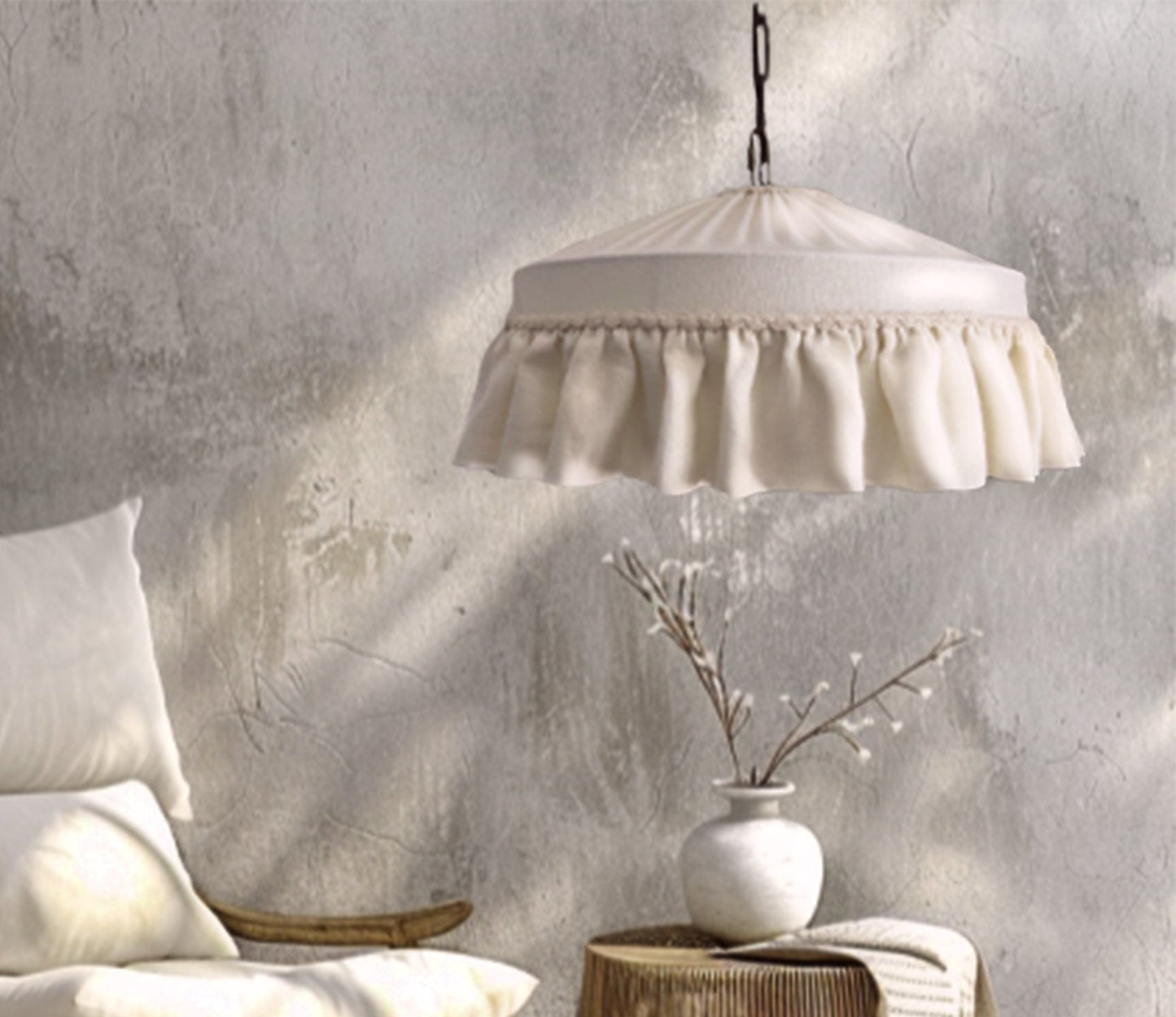 White pendant lamp hanging above a textured wall with decorative elements.