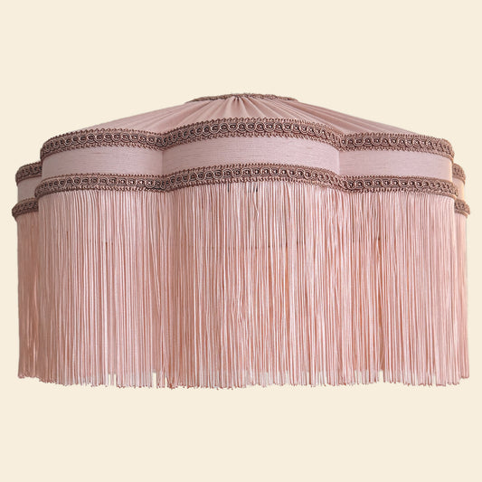 Decorative lampshade with fringe and intricate detailing on a beige background The House of Soft Light