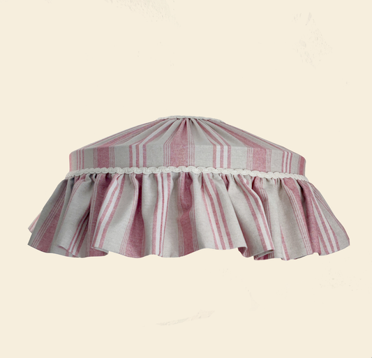 Striped lampshade with ruffled edge on a beige background
