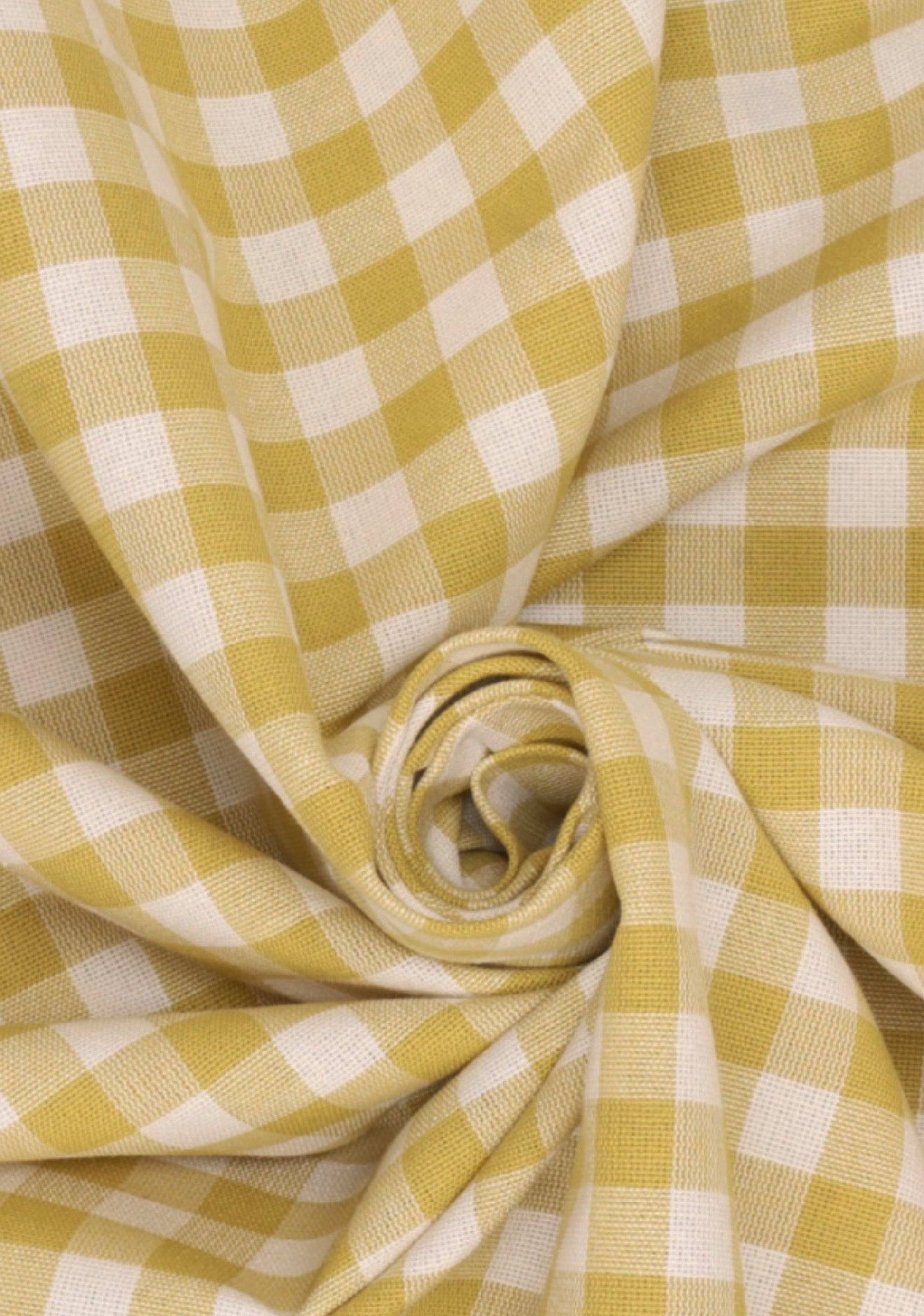 Close-up of yellow rustic gingham fabric with soft cotton texture, ideal for handcrafted ruffle lampshades in cottage core home decor.